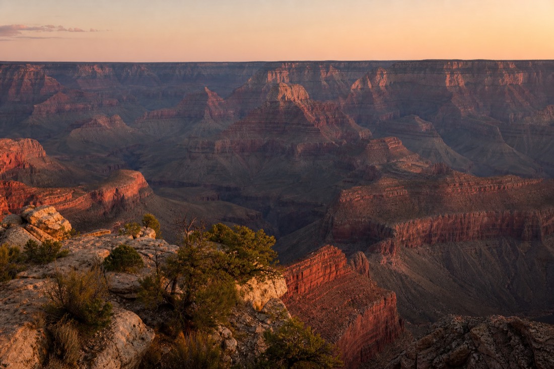 Grand Canyon South Rim's layered cliffs stretching to the horizon at dusk