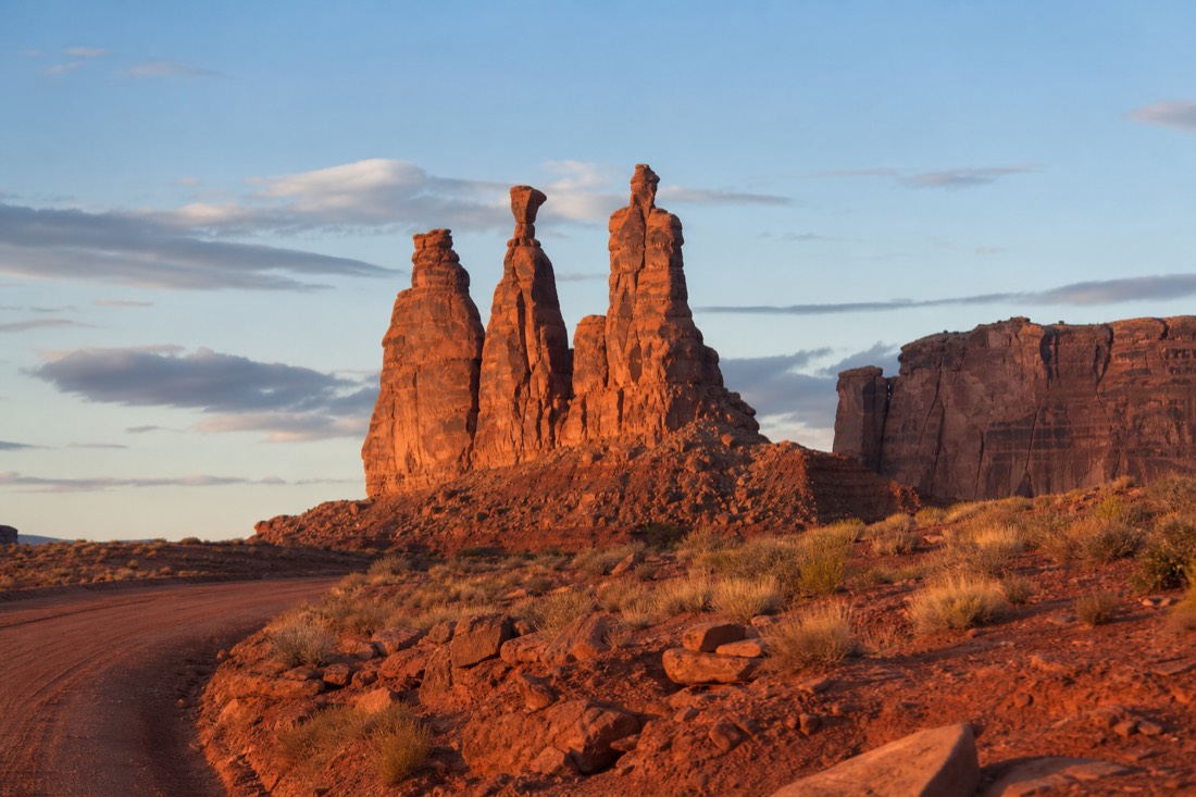 The slender Three Sisters rock spires seen from a pullout along the red dirt loop road
