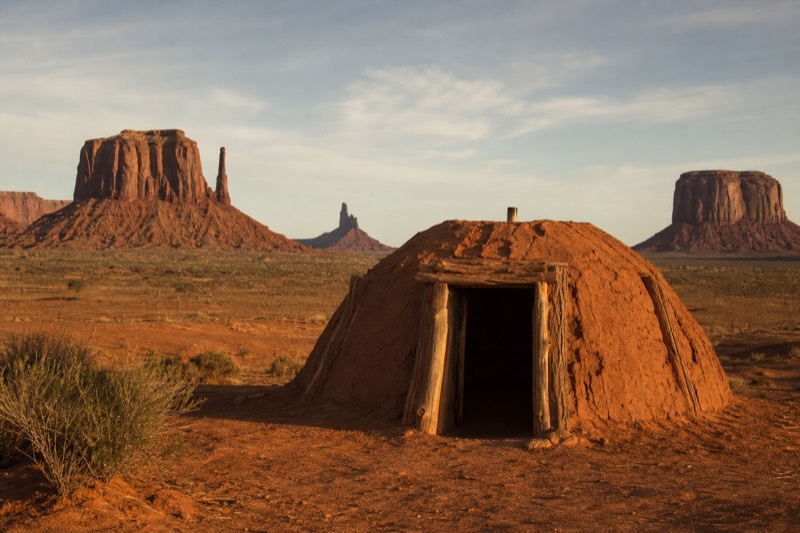 A traditional Navajo hogan and a guide sharing culture inside the Monument Valley Navajo Tribal Park